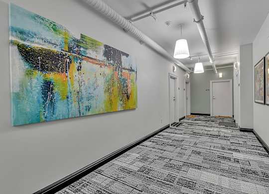 office space with artwork on the wall and hallway with white doors at 100 South Apartments, Buffalo, 14202