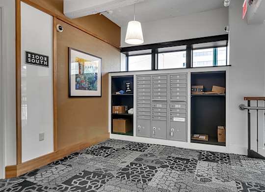 a lockers room in a hallway with a staircase and windows at 100 South Apartments, New York