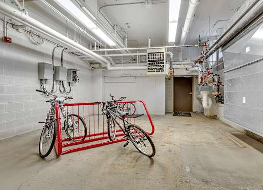 a bike rack with two bikes in the middle of a room at 100 South Apartments, Buffalo