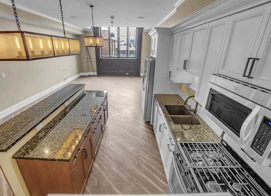 a kitchen with granite counter tops and stainless steel appliances at The Knights @ 506 Delaware Apartments, Buffalo, New York