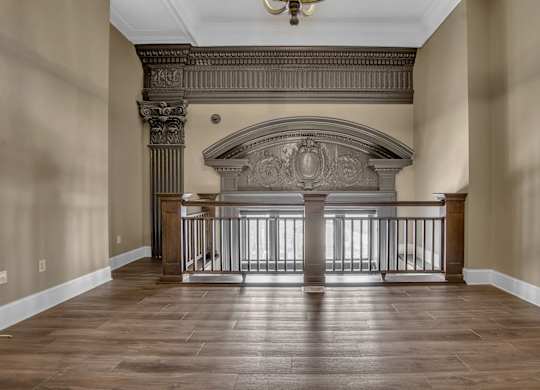 a living room with a fireplace and a wooden floor at The Knights @ 506 Delaware Apartments, Buffalo, 14202