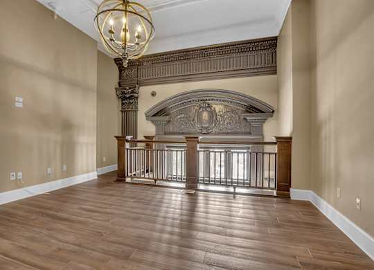 a large living room with a fireplace and a wooden floor at The Knights @ 506 Delaware Apartments, Buffalo, 14202