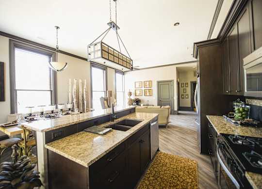 a kitchen and living room with a large counter top at The Knights @ 506 Delaware Apartments, Buffalo