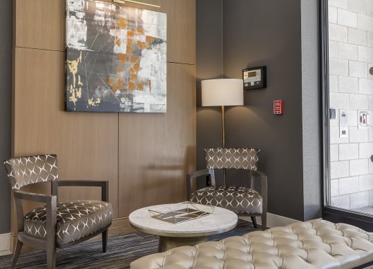 a lobby with a table and chairs and a chandelier at Nineteen North, Buffalo, NY