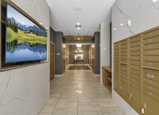 a view of a hallway with mailboxes and a television on the wall at Nineteen North, New York, 14202
