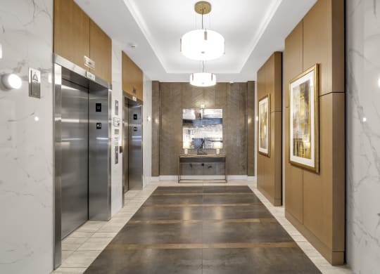 a long hallway with marble floors and stainless steel appliances at Nineteen North, New York, 14202