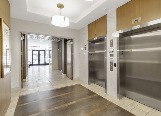 a lobby with elevators and a hallway with doors at Nineteen North, Buffalo, New York