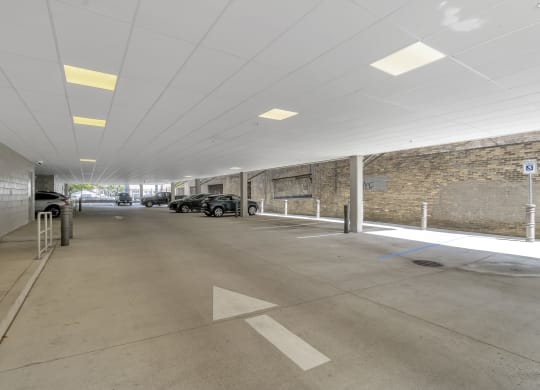 a parking garage with cars and a brick wall at Nineteen North, Buffalo, NY