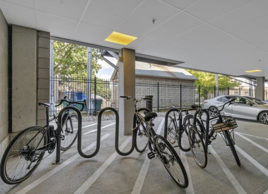 a row of bikes parked inside of a parking garage at Nineteen North, Buffalo, 14202