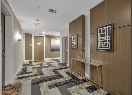 a hallway with carpeted floors and wooden walls and doors at Nineteen North, Buffalo, NY