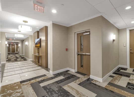 a hallway with elevators and doors in a building at Nineteen North, Buffalo