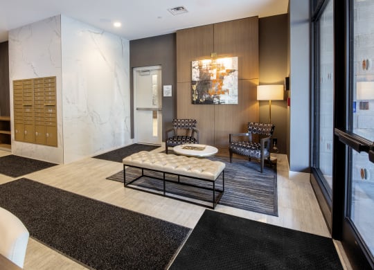 a lobby with a seating area and a table at Nineteen North, Buffalo, NY