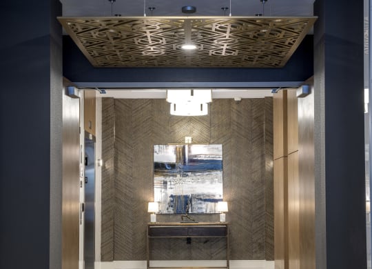 a view of the elevator lobby of a building with a blue and gold elevator lobby at Nineteen North, New York, 14202