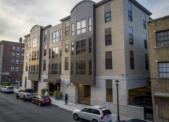 a new apartment building on a city street with cars at Nineteen North, Buffalo