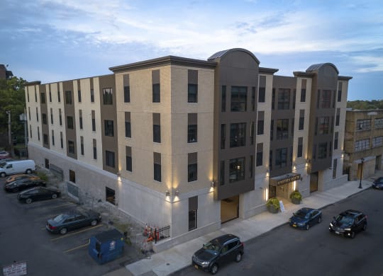 a large apartment building with cars parked in front of it at Nineteen North, Buffalo, New York