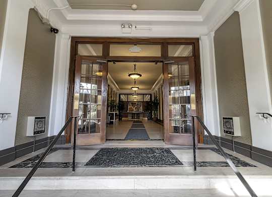 a view of the entrance to the lobby of a building with glass doors at The Knights @ 506 Delaware Apartments, Buffalo, NY 14202
