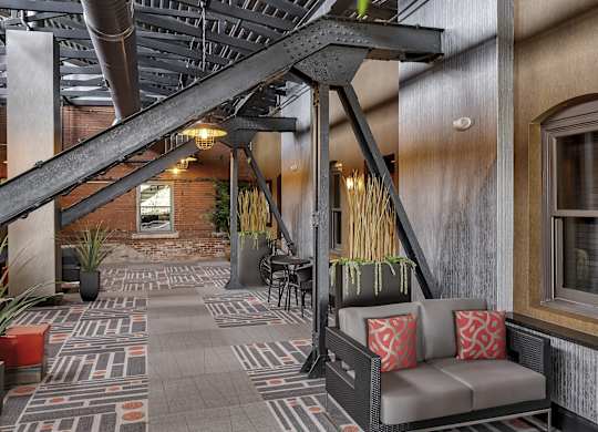 a lobby with a seating area and a staircase at The Knights @ 506 Delaware Apartments, Buffalo