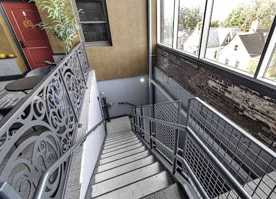 a view of the balcony with stairs and a brick wall at The Knights @ 506 Delaware Apartments, New York, 14202