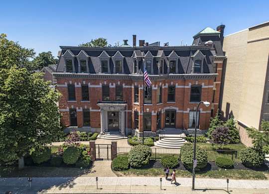 an aerial view of a brick building with an flag at The Knights @ 506 Delaware Apartments, New York, 14202