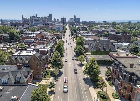 an aerial view of a city street with cars and buildings at The Knights @ 506 Delaware Apartments, Buffalo