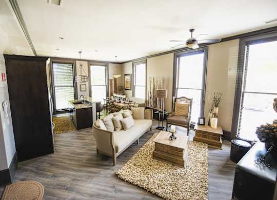 a living room filled with furniture and a ceiling fan at The Knights @ 506 Delaware Apartments, Buffalo, NY