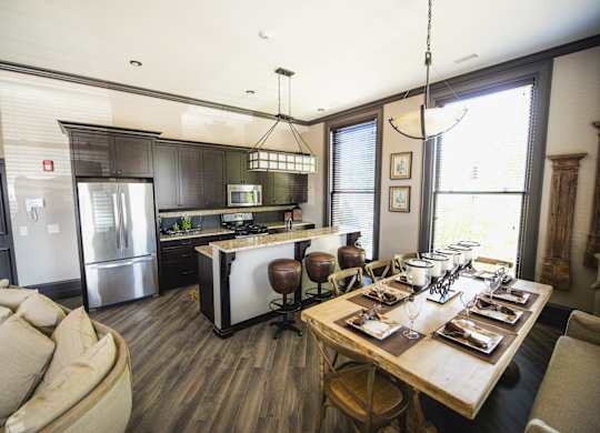 a kitchen and dining room with a table and chairs at The Knights @ 506 Delaware Apartments, Buffalo, NY 14202