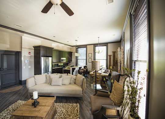 a living room and kitchen with a couch and a table at The Knights @ 506 Delaware Apartments, New York, 14202