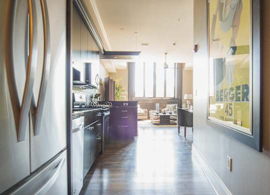 a view of a kitchen and a living room from a hallway at The Knights @ 506 Delaware Apartments, Buffalo, NY