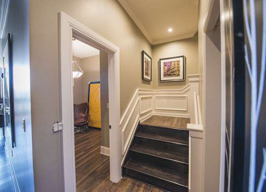 the landing of a staircase in a home with wood floors and white walls at The Knights @ 506 Delaware Apartments, Buffalo, NY 14202