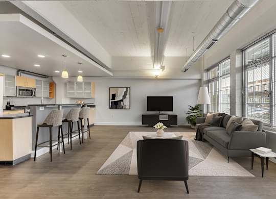 Open concept living room with modern furnishings at The Lofts at Elk Terminal Apartments, Buffalo, NY 14204