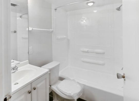 a white bathroom with a shower sink and toilet at Walnut Towers at Frick Park, Pittsburgh, Pennsylvania