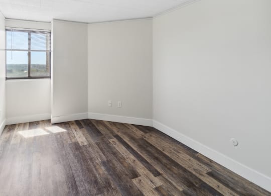 an empty room with wood floor at Walnut Towers at Frick Park, Pittsburgh, PA 15217