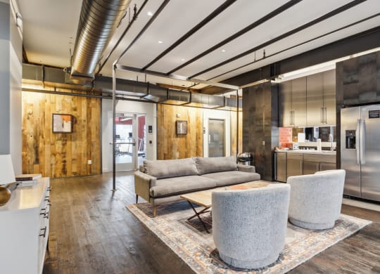 a living room with a couch and chairs and a kitchen at Bakery Living, Pittsburgh, PA