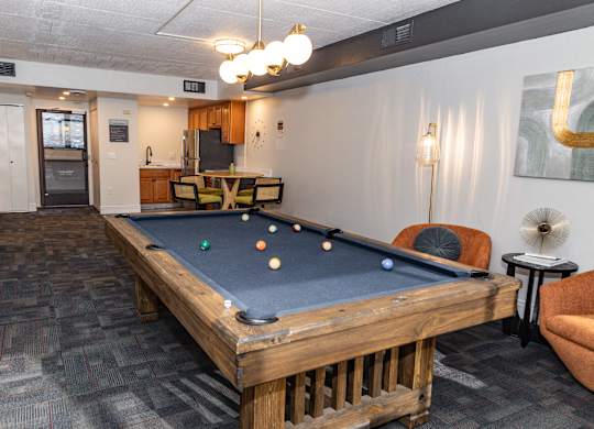 A pool table in a room with a couch and a fan at Walnut Towers at Frick Park, Pennsylvania 15217