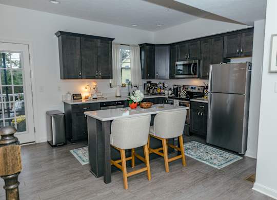 A kitchen with a table and chairs in the middle of it. at Highland Village, Ross Township, Pittsburgh, PA 15229