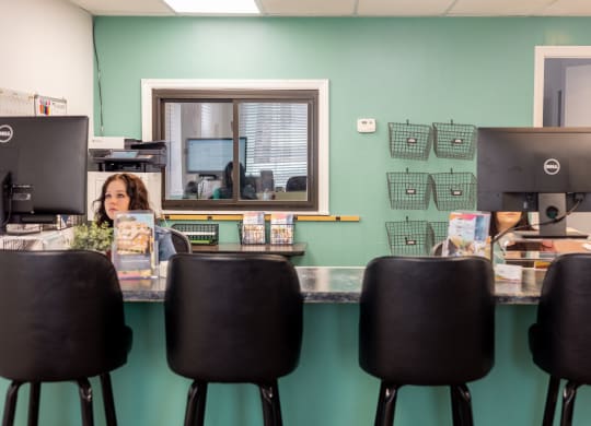 a woman sitting at a desk in front of a computer at University Commons Apartments, Oakland, Pittsburgh