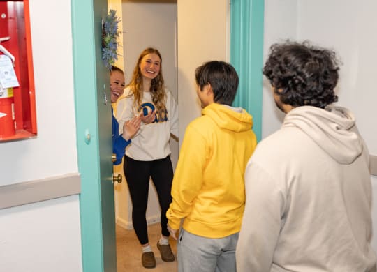 a group of people standing in front of a mirror at University Commons Apartments, Oakland, Pittsburgh