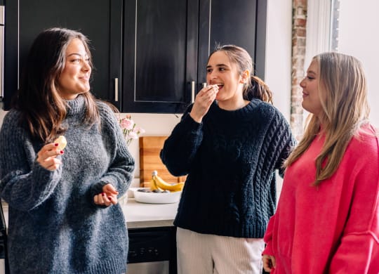 a group of women eating ice cream in a kitchen at University Commons Apartments, Oakland, Pittsburgh