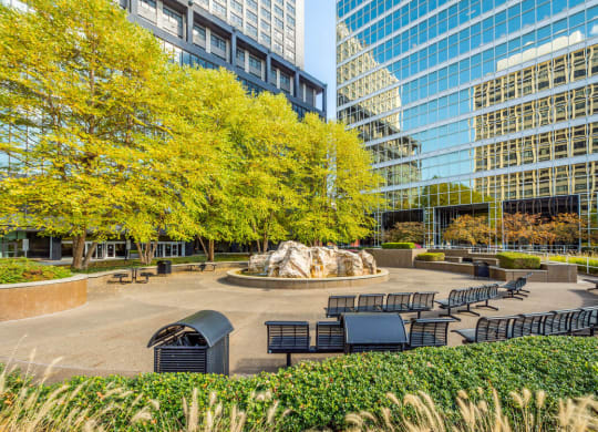 a park with a fountain and benches in front of skyscrapers at The Washington at Chatham, Pittsburgh, PA