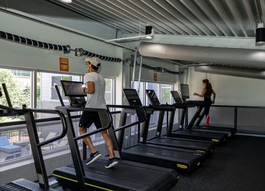 a man and a woman running on treadmills in a gym at Bakery Living in Pittsburgh, PA 15206