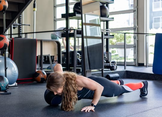 a woman doing a plank in a gym at Bakery Living in Pittsburgh, PA 15206