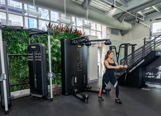 a woman is running on a treadmill in a gym at Bakery Living in Pittsburgh, PA 15206