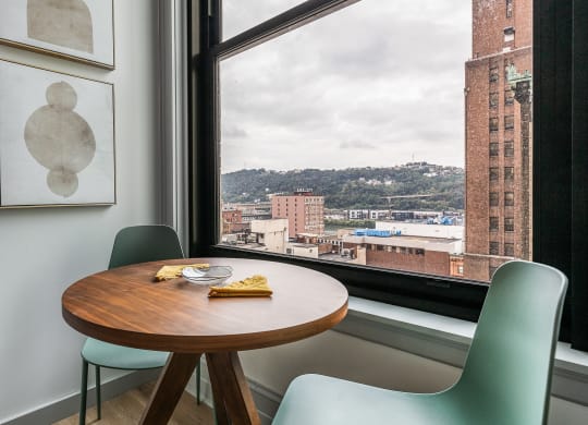 a small table in front of a window with a city view at The Commonwealth Building, Pittsburgh, Pennsylvania