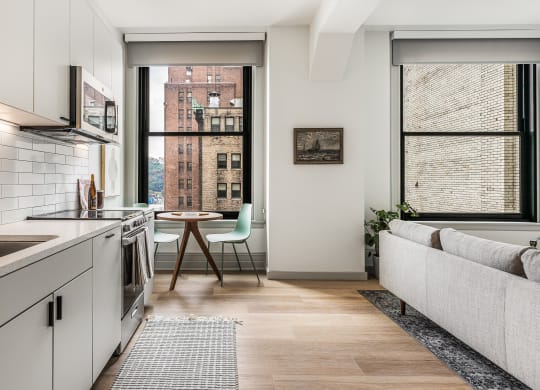 a kitchen with white cabinets and a sink and a window at The Commonwealth Building, Pittsburgh