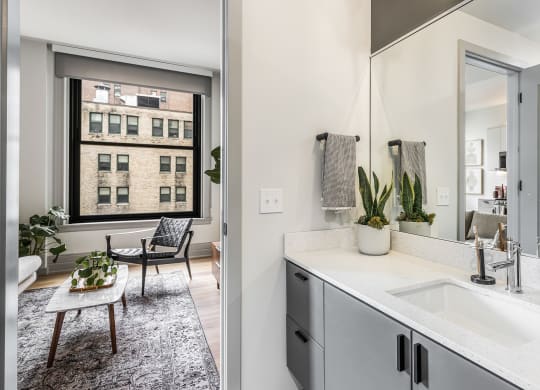 a bathroom with a sink and a mirror and a window at The Commonwealth Building, Pittsburgh