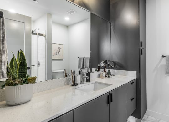 a bathroom with a sink and a shower and a mirror at The Commonwealth Building, Pennsylvania
