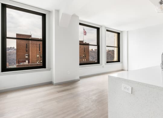 a kitchen with a large window and a white counter top at The Commonwealth Building, Pittsburgh, 15222