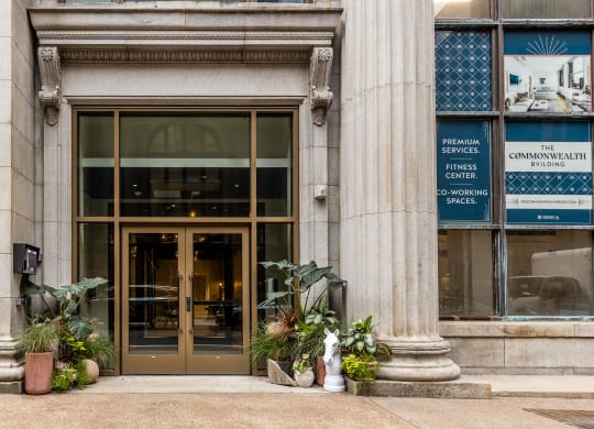 the front of a building with a bronze door and potted plants at The Commonwealth Building, Pittsburgh, Pennsylvania