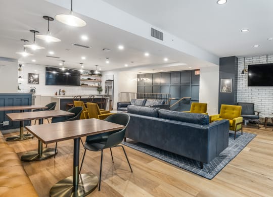 a living room with couches tables and chairs and a tv at The Commonwealth Building, Pittsburgh, 15222