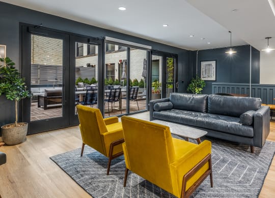 a living room with blue walls and yellow chairs and a couch at The Commonwealth Building, Pittsburgh, Pennsylvania